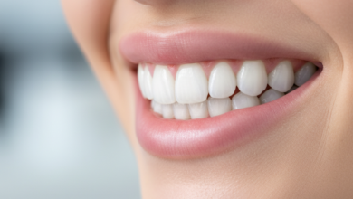 Close-up of a person's radiant, perfectly aligned, bright white smile, showcasing flawless teeth and healthy lips against a softly blurred, sophisticated background. The image emphasizes the beauty and confidence associated with cosmetic dentistry, suggesting celebrity-level dental perfection without showing any text or symbols.