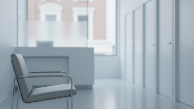 An empty, pristine, and modern dental waiting room, featuring a single, unoccupied gray waiting chair in the foreground. In the blurred background, a reception desk and several closed white doors of treatment rooms are visible, hinting at unavailability. Through a large window, a very subtle, out-of-focus suggestion of British red-brick architecture can be seen outside, emphasizing a UK setting. The scene is quiet, sterile, and conveys a sense of prolonged waiting and inaccessibility.